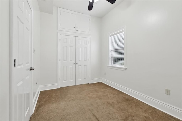 3316 Calhoun St, New Orleans, LA 70125 - unfurnished bedroom with dark carpet, baseboards, a closet, and ceiling fan