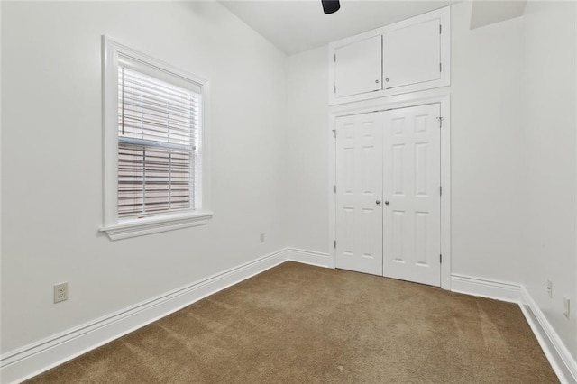 3316 Calhoun St, New Orleans, LA 70125 - unfurnished bedroom with dark carpet, baseboards, and a closet