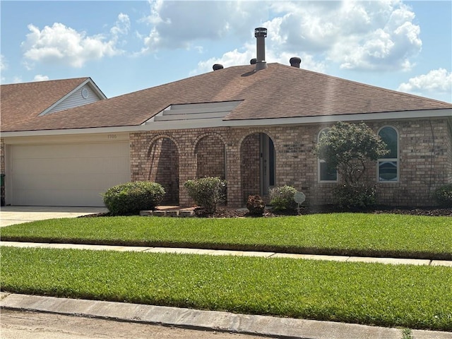 1705 Armagh Dr, Marrero, LA 70072 - view of front of home featuring an attached garage, roof with shingles, a front lawn, driveway, and brick siding