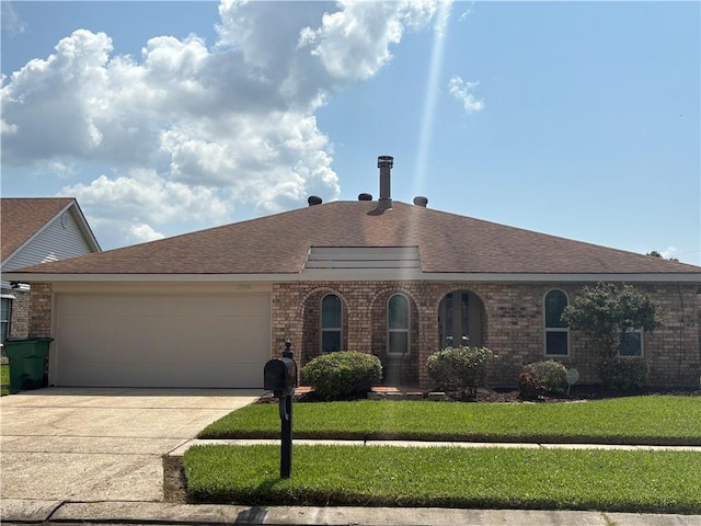 1705 Armagh Dr, Marrero, LA 70072 - view of front facade with a garage, driveway, brick siding, and a front yard