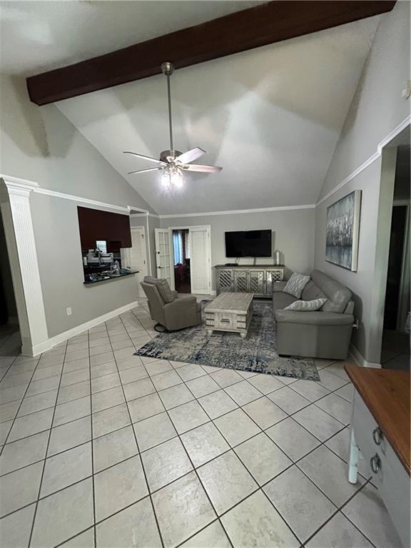 1705 Armagh Dr, Marrero, LA 70072 - living area with light tile patterned floors, ceiling fan, beam ceiling, baseboards, and high vaulted ceiling