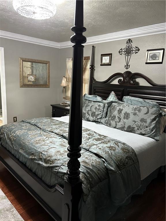 1705 Armagh Dr, Marrero, LA 70072 - bedroom with ornamental molding, wood finished floors, and a textured ceiling