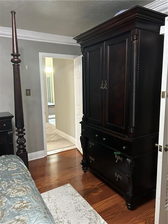1705 Armagh Dr, Marrero, LA 70072 - bedroom with wood finished floors, ornamental molding, and baseboards