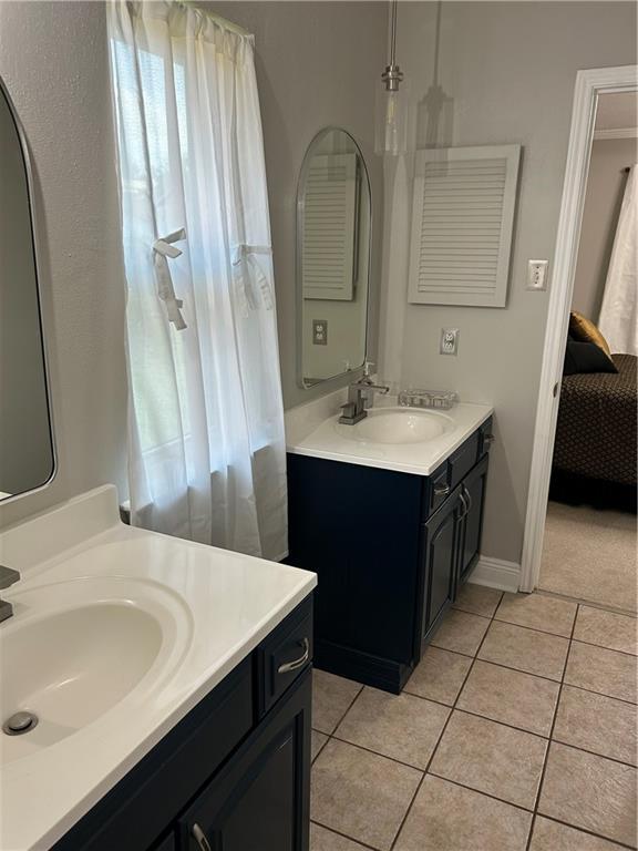 1705 Armagh Dr, Marrero, LA 70072 - ensuite bathroom with two vanities and tile patterned floors