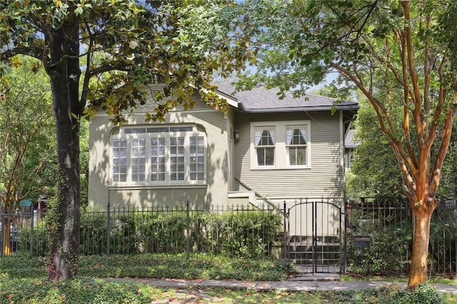 1665 Dufossat St, New Orleans, LA 70115 - back of house with stucco siding and a gate