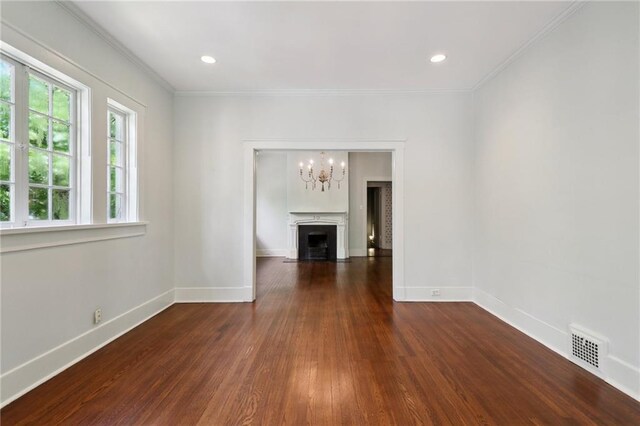 1665 Dufossat St, New Orleans, LA 70115 - unfurnished living room with wood finished floors, a chandelier, baseboards, a fireplace with flush hearth, and crown molding