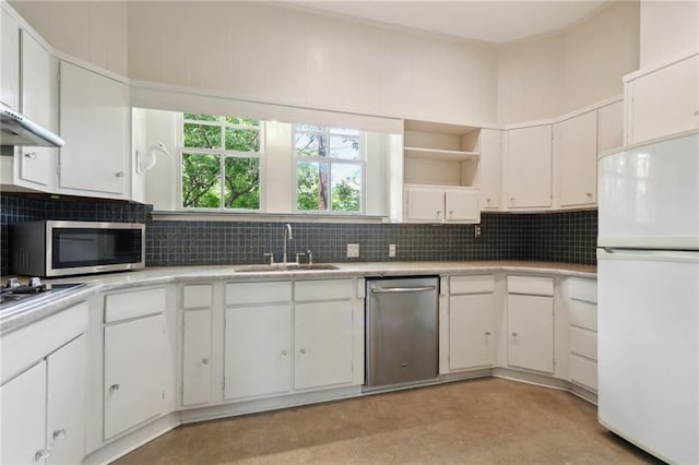 1665 Dufossat St, New Orleans, LA 70115 - kitchen with appliances with stainless steel finishes, a sink, open shelves, light countertops, and decorative backsplash