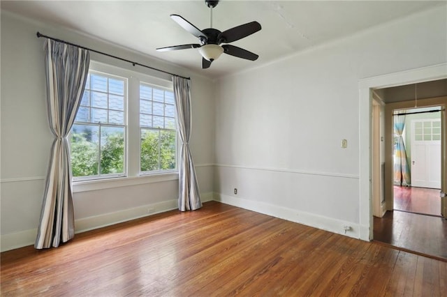 1665 Dufossat St, New Orleans, LA 70115 - unfurnished room featuring hardwood / wood-style floors, baseboards, and a ceiling fan