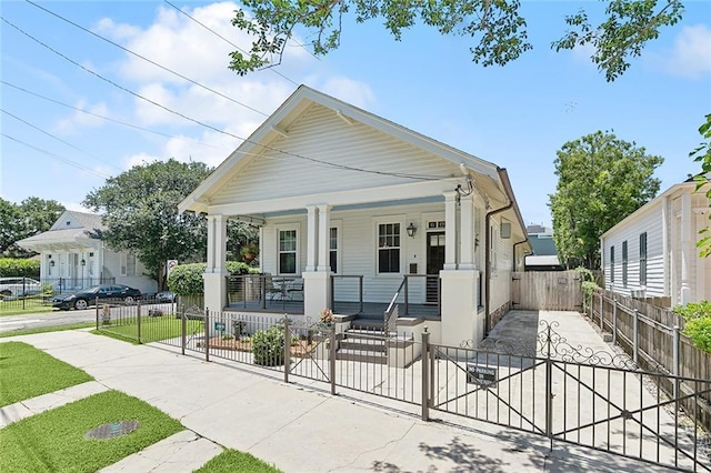 602 Jefferson Ave, New Orleans, LA 70115 - view of front of house with a porch, a fenced front yard, and a gate