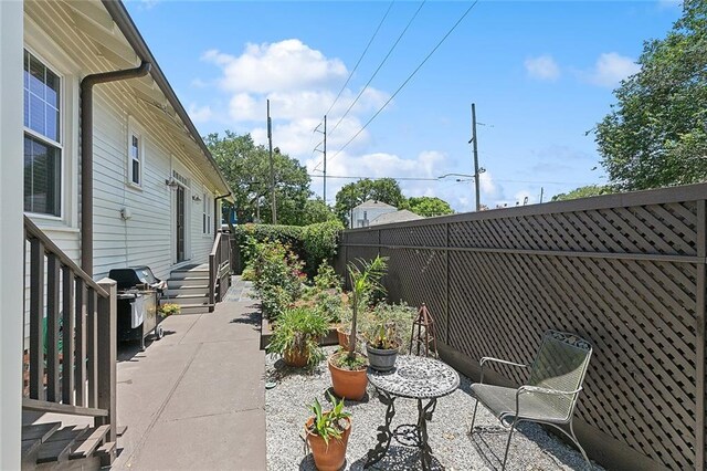 602 Jefferson Ave, New Orleans, LA 70115 - fenced backyard featuring a grill and a patio