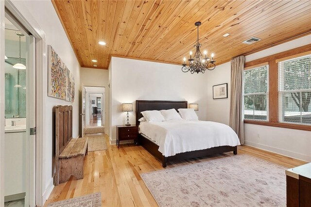 602 Jefferson Ave, New Orleans, LA 70115 - bedroom with light wood-style flooring, a chandelier, wood ceiling, baseboards, and ensuite bath