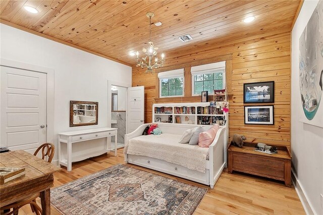 602 Jefferson Ave, New Orleans, LA 70115 - bedroom featuring a chandelier, light wood-style floors, wood walls, recessed lighting, and baseboards