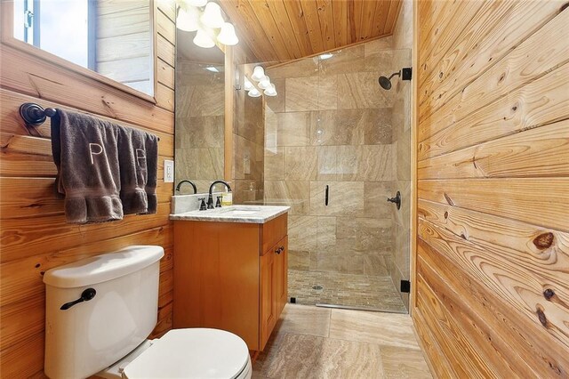 602 Jefferson Ave, New Orleans, LA 70115 - full bath with toilet, vanity, tiled shower, wooden walls, and wooden ceiling