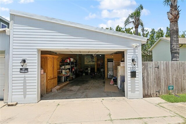 602 Jefferson Ave, New Orleans, LA 70115 - garage with concrete driveway and freestanding refrigerator