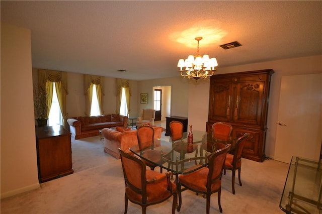 102 Apple Ct, Luling, LA 70070 - dining space featuring light carpet, a chandelier, and a textured ceiling