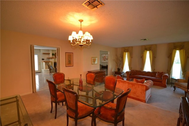 102 Apple Ct, Luling, LA 70070 - dining room featuring light colored carpet, a chandelier, and a textured ceiling