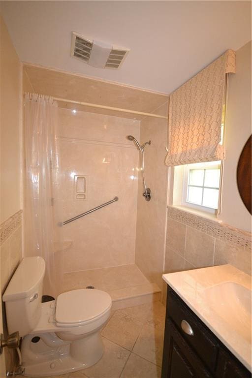 102 Apple Ct, Luling, LA 70070 - full bath with tile walls, toilet, a shower with shower curtain, vanity, and tile patterned floors