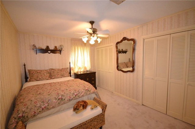 102 Apple Ct, Luling, LA 70070 - bedroom featuring wallpapered walls, multiple closets, light carpet, ceiling fan, and baseboards