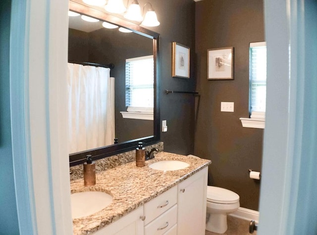 43357 Quiet Lake Dr, Hammond, LA 70403 - bathroom featuring double vanity, toilet, a shower with curtain, and baseboards