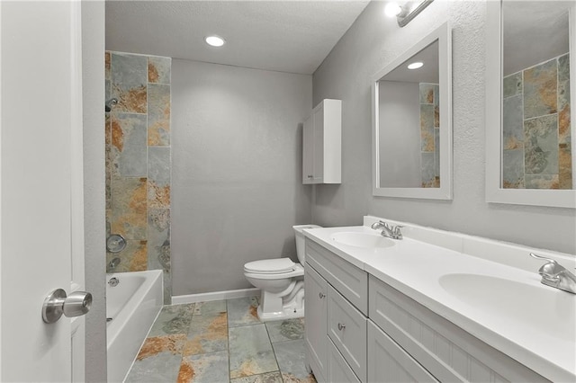 312 Tamarack St, Gretna, LA 70056 - bathroom featuring double vanity, toilet, stone finish flooring, baseboards, and shower / tub combination