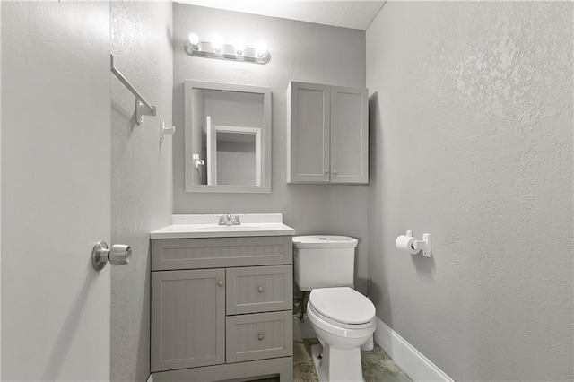 312 Tamarack St, Gretna, LA 70056 - bathroom with toilet, vanity, baseboards, and a textured wall
