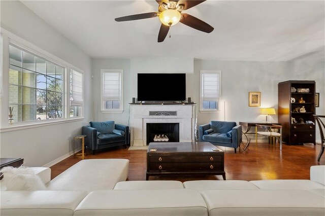 6118 Canal Blvd, New Orleans, LA 70124 - living area featuring wood finished floors, a fireplace with flush hearth, a ceiling fan, and baseboards