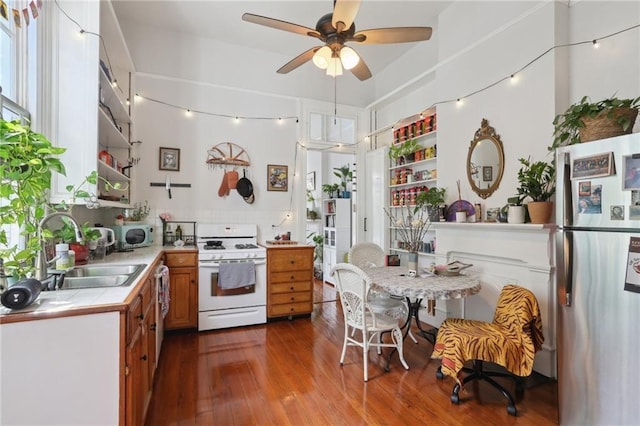 921-23 Hagan Ave, New Orleans, LA 70119 - kitchen with stainless steel appliances, a sink, tile counters, open shelves, and dark wood-type flooring