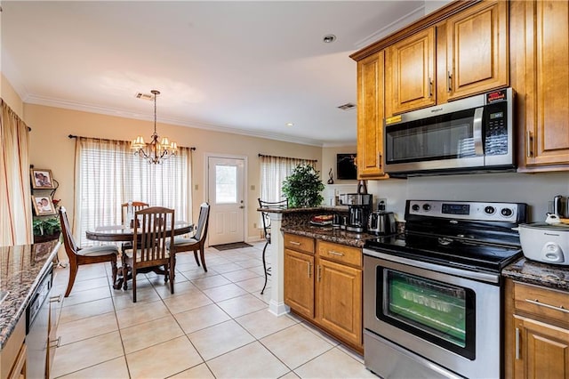 1326 Prentiss Ave, New Orleans, LA 70122 - kitchen with appliances with stainless steel finishes, a chandelier, brown cabinets, and ornamental molding
