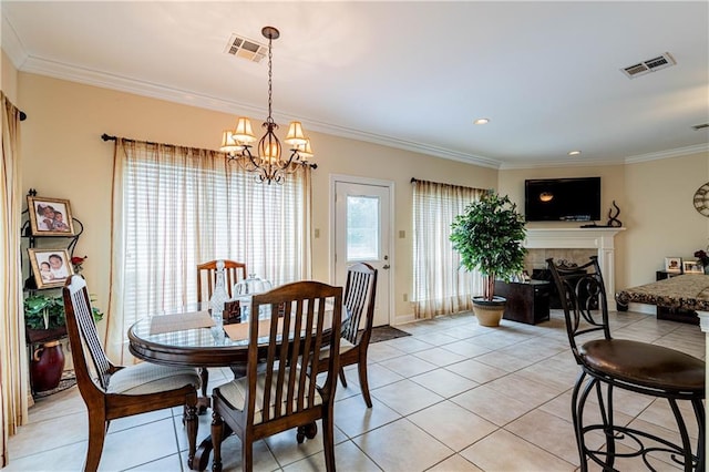 1326 Prentiss Ave, New Orleans, LA 70122 - dining room featuring a chandelier, light tile patterned floors, crown molding, and a fireplace