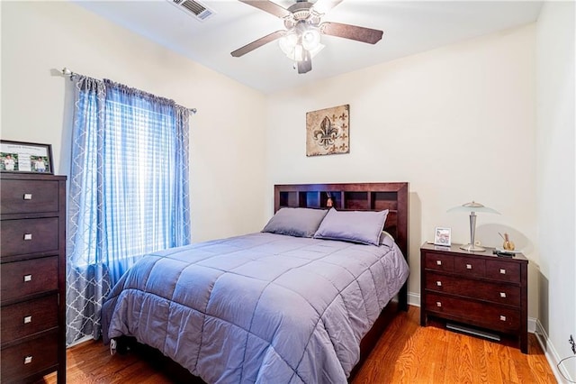 1326 Prentiss Ave, New Orleans, LA 70122 - bedroom featuring wood finished floors, ceiling fan, and baseboards