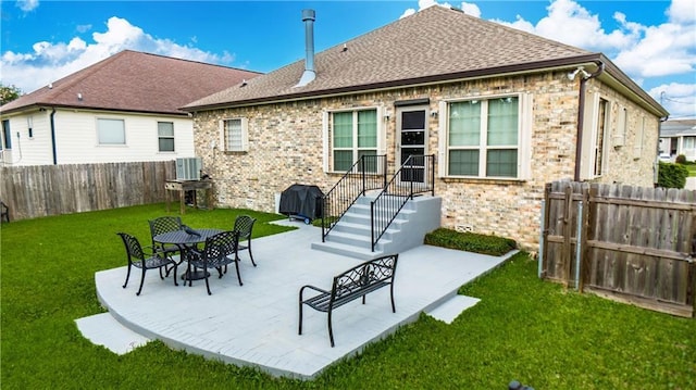 1326 Prentiss Ave, New Orleans, LA 70122 - back of property featuring central AC, brick siding, roof with shingles, and a patio