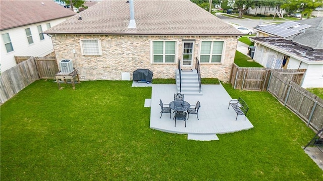 1326 Prentiss Ave, New Orleans, LA 70122 - rear view of property featuring brick siding, a patio area, central AC unit, and roof with shingles