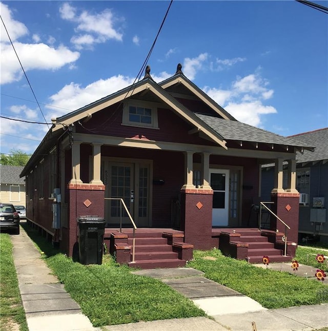 853335 Forshey St, New Orleans, LA 70118 - bungalow-style house with covered porch and roof with shingles