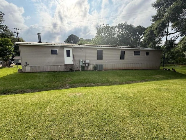 201 Sparrow St, New Iberia, LA 70563 - rear view of house with a yard, central air condition unit, and metal roof