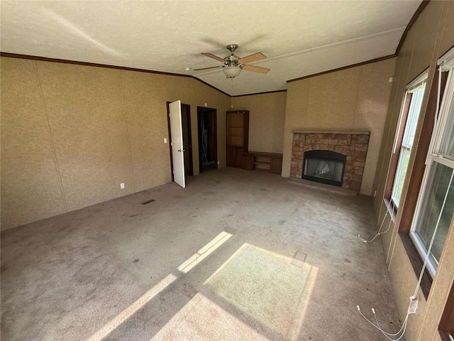 201 Sparrow St, New Iberia, LA 70563 - unfurnished living room featuring crown molding, ceiling fan, a stone fireplace, vaulted ceiling, and a decorative wall