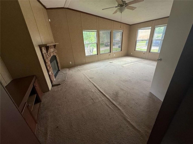 201 Sparrow St, New Iberia, LA 70563 - unfurnished living room featuring lofted ceiling, light colored carpet, ceiling fan, a stone fireplace, and ornamental molding