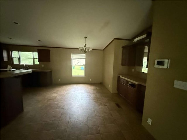 201 Sparrow St, New Iberia, LA 70563 - kitchen featuring healthy amount of natural light, a chandelier, crown molding, and vaulted ceiling