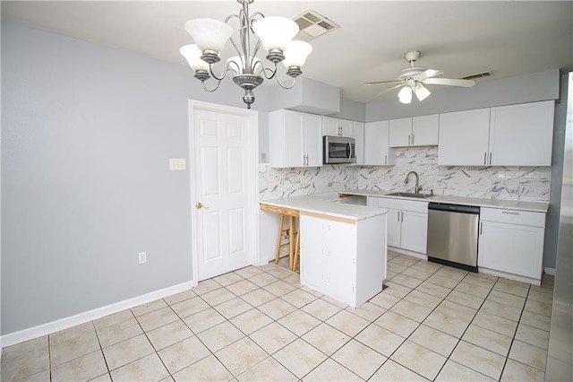 2804 Transcontinental Dr, Metairie, LA 70006 - kitchen with appliances with stainless steel finishes, a sink, a peninsula, tasteful backsplash, and ceiling fan