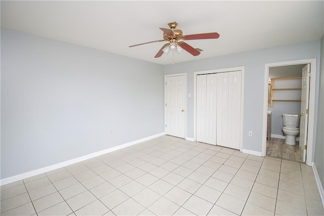 2804 Transcontinental Dr, Metairie, LA 70006 - unfurnished bedroom featuring baseboards, light tile patterned floors, and a ceiling fan