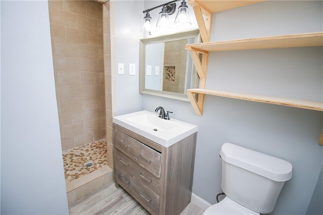2804 Transcontinental Dr, Metairie, LA 70006 - full bathroom with vanity, tiled shower, toilet, and wood finished floors