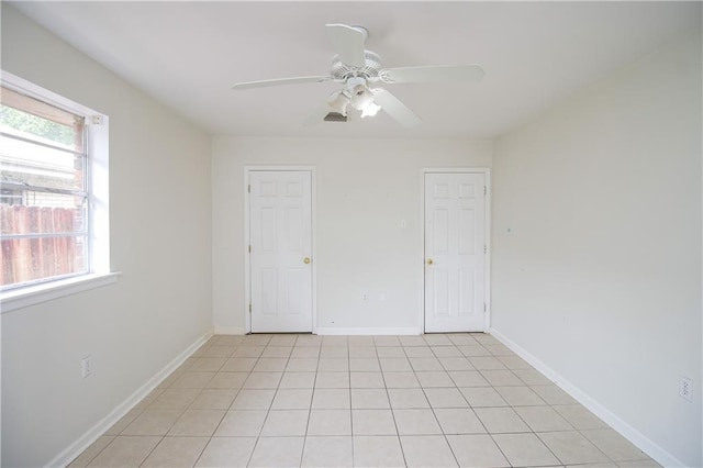 2804 Transcontinental Dr, Metairie, LA 70006 - empty room featuring a ceiling fan, light tile patterned floors, and baseboards