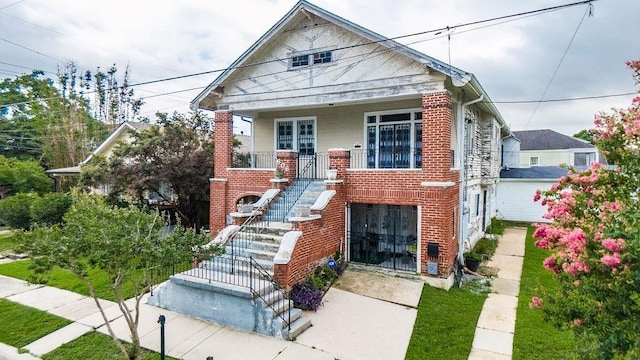 606 Filmore St, New Orleans, LA 70124 - view of front of property featuring stairway, brick siding, and a porch