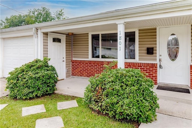 1801 River Oaks Dr, New Orleans, LA 70131 - view of exterior entry featuring brick siding, covered porch, and an attached garage