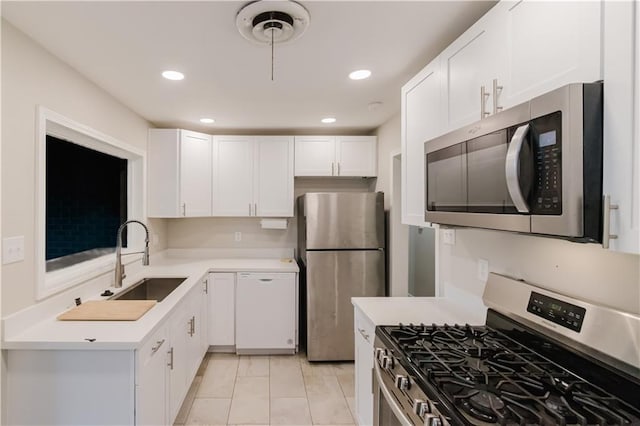1801 River Oaks Dr, New Orleans, LA 70131 - kitchen with appliances with stainless steel finishes, a sink, light countertops, white cabinetry, and recessed lighting