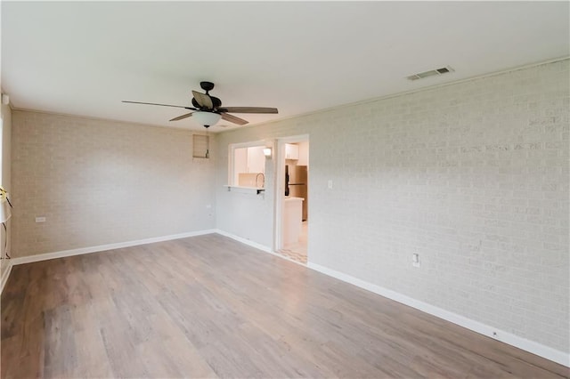1801 River Oaks Dr, New Orleans, LA 70131 - empty room with ceiling fan, baseboards, wood finished floors, and brick wall