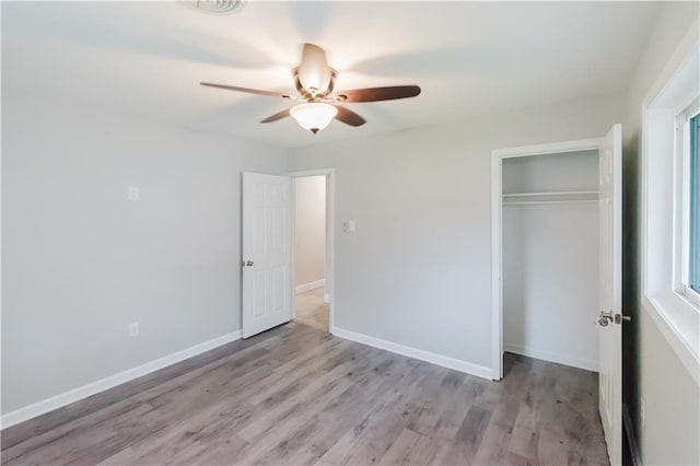 1801 River Oaks Dr, New Orleans, LA 70131 - unfurnished bedroom with a closet, light wood-style floors, a ceiling fan, and baseboards