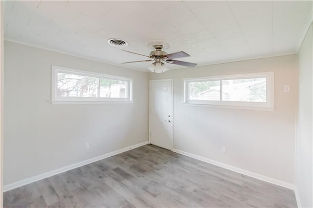 1801 River Oaks Dr, New Orleans, LA 70131 - empty room featuring plenty of natural light, a ceiling fan, light wood finished floors, and baseboards