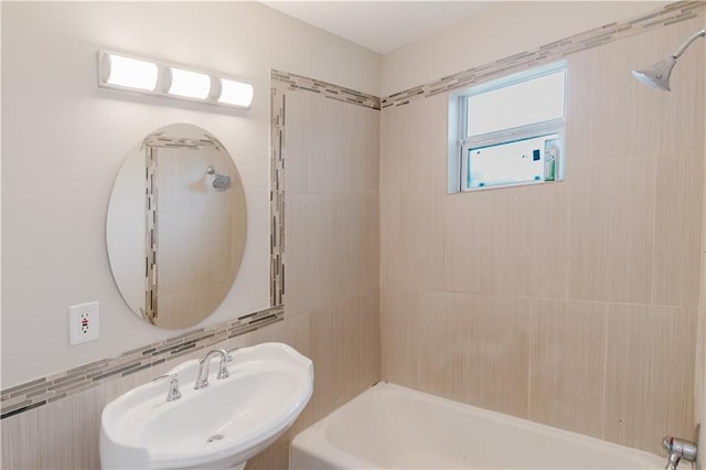 1801 River Oaks Dr, New Orleans, LA 70131 - bathroom with a sink, shower / washtub combination, and tile walls