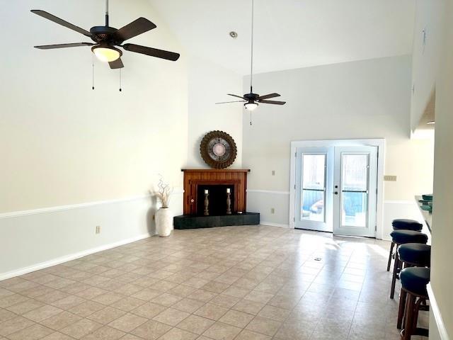 4231 San Trovaso St, New Orleans, LA 70129 - living area with a ceiling fan, high vaulted ceiling, and a fireplace with raised hearth