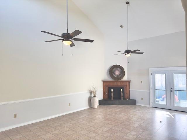 4231 San Trovaso St, New Orleans, LA 70129 - unfurnished living room featuring ceiling fan, high vaulted ceiling, and french doors